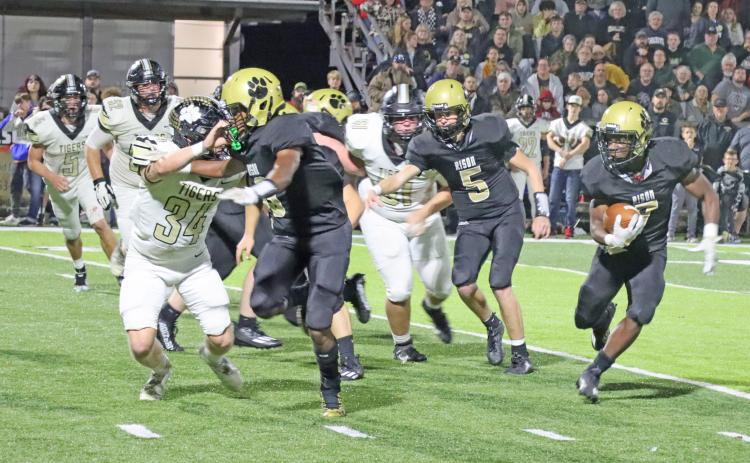 TESTING THE EDGE - Rison’s ZaKyler Walker (left, no. 3) looks to set a block on Charleston’s Bryton Keller (no. 34) as DJ Kines (right) looks to break outside after taking the handoff from quarterback Blaine Dixon (no. 5). The Wildcats’ two senior running backs, Kines and Bradyn Dupuy, led Rison in rushing with 69 and 66 yards, respectively. (Photo by Chris Phillips)