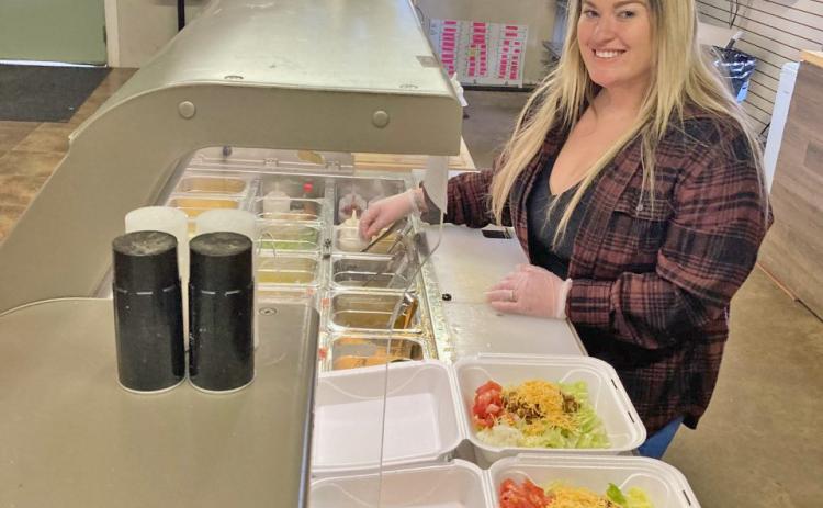 EXPANDING THE MENU - Lauren Dively prepares a couple of taco salads during the lunch hour on Tuesday at the new Dively's One Stop in Rowell. Dively said they are always looking for ways to expand their menu, and on Tuesday the business held its first-ever "Taco Tuesday."