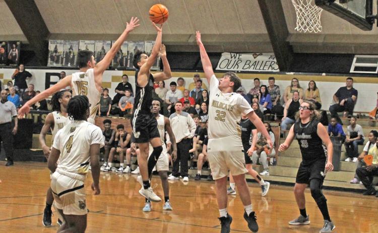 BEARS TURN BACK WILDCATS - Woodlawn’s Jaxson Martin (center) delivers a floater over Rison defenders Owen Morrison (no. 15) and Thomas Wilson (no. 32) late in the fourth quarter as the Bears held on for a 77-70 victory over the Wildcats in a renewal of the Cleveland County rivalry Tuesday night at the Rison Gym.