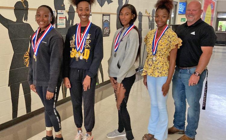 CLASS 2A 4x200 RELAY STATE CHAMPIONS - (Left to right) Shermyah Bracey, La'Drea Hamilton, Destiny Lea, Brianna Ferrell and Coach Zach Branch pose for a photo after winning the 4x200 relay at the Class 2A State Track Meet at Quitman. All four have family members who excelled in track and athletics as well.