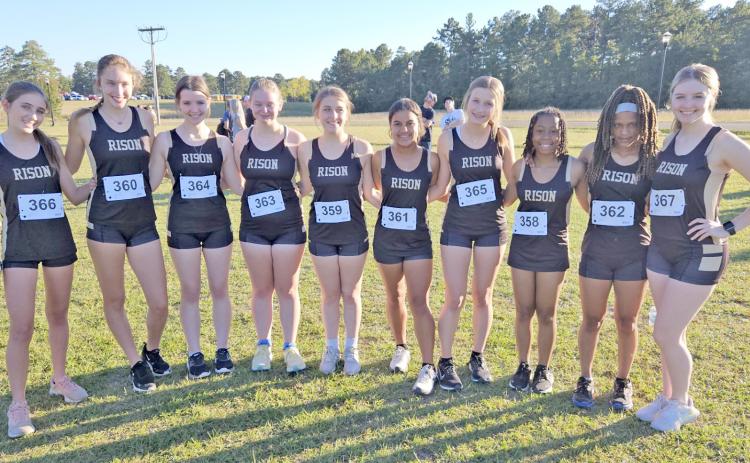 SOUTH REGION CHAMPIONS - Members of the Rison Lady Wildcat cross country team pose for a team photo after winning the Class 1A/2A South Region Cross Country Championship on Oct. 17 at El Dorado. Pictured are (left to right) Lara Sotres, Olivia McCarty, Ragan Shrum, Harley Rowland, Victoria James, Rhagen Price, Haven Simpson, Kayla Jackson, Ariel Rainey and Anna Vallance.