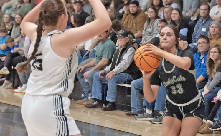 POTTER FUELS LADY ‘CATS - Rison junior Layne Potter (right) prepares to launch a jumper over Woodlawn’s Lillie Faye McWhorter (left) during last Thursday’s game between the county rivals inside a packed Woodlawn gym. Potter had one of her best games of the year, leading all scorers with 20 points. (Photo by Kelvin Scott/Cardboard Sports)