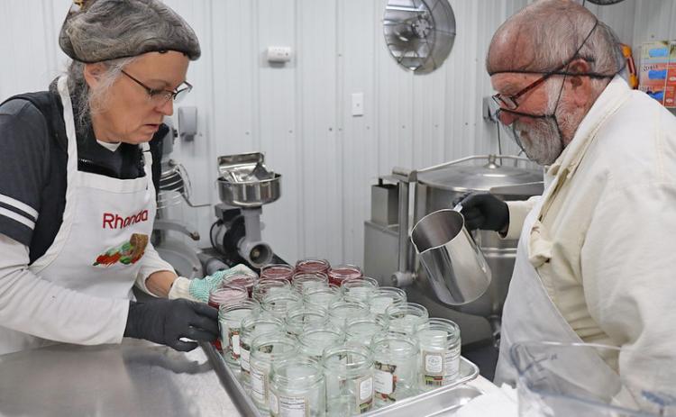 TEAMWORK — Rhonda and Ken Rudder, owners of Richland Creek Farm & Market in El Dorado, prepare their Mayhaw jelly jars at the Share Grounds processing kitchen located at the Cleveland County Farigrounds in Rison. The commercial grade kitchen can be rented by aspiring food entrepreneurs to get their product on the retail store shelf.  (Division of Agriculture photo.)