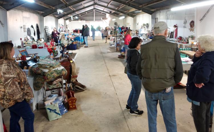 VILLAGE SEES CROWD OF JUNKERS - Shoppers from all over stop by the Pioneer Village Saturday, March 9 to browse the junk for sale as part of the Great South Arkansas Junk Hunt. Organizer Jennifer Via reported people traveling the 600-plus mile route from neighboring states and as far away as Iowa, Pennsylvania and Wisconsin. Rison's Pioneer Village served as one the hub locations with multiple vendors set up selling junk.