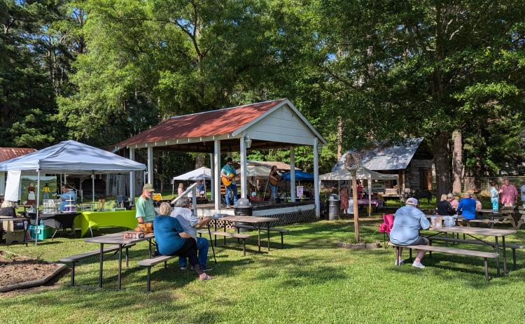Attendees enjoy the Rison Farmers Market vendors and live entertainment from duo Laura Caroline and Brian Mullen.