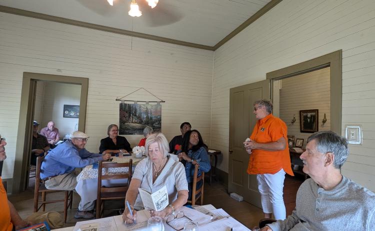 Pictured above is Pioneer Village President Marty Bowlin (standing) sharing the history of the historic property.
