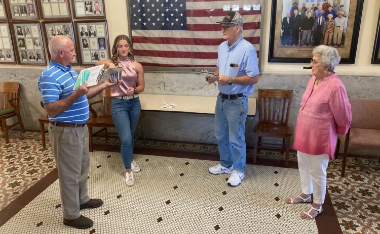 Cleveland County Election Coordinator Billy Bowlin (left) holds a bucket while Woodlawn High School senior Sarah Beth Melhorn (second from left) draws names to determine the order that the presidential candidates will appear on the 2024 general election ballot in Cleveland County.