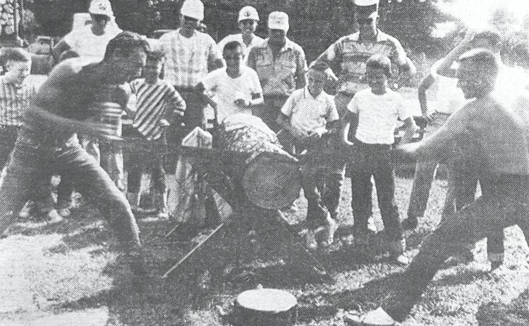 GLIMPSES  FROM  THE  PAST - For our last look back this month at Cleveland County fairs from the past, we go to the 1962 event in which there was a forestry activity conducted that included a log sawing contest. These two International Paper Co. employees, David Hale, left, and John Reed, right, make the sawdust fly in giving a sawing demonstration as part of the activity. The pair cut through the log in about 37 seconds. For questions or comments, contact Stan Sadler at sadler.stan@yahoo.com