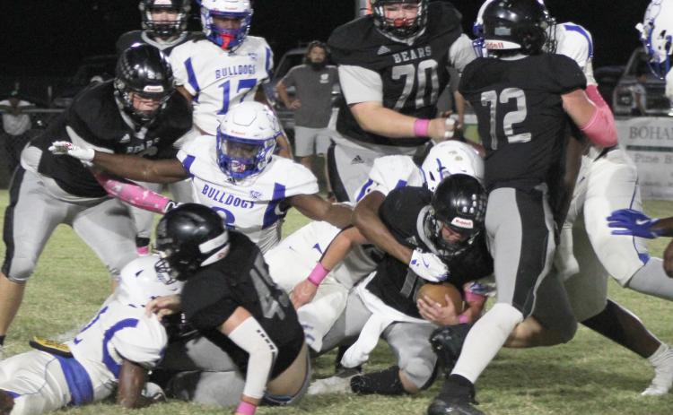 TOUGH RUNNING - Woodlawn senior fullback Ethan Oliver (center) fights for yardage against a big and fast Strong defense in first half action Friday night. Oliver ended up leading Woodlawn in rushing with 55 yards on 13 carries after the Bulldogs came after the Bears’ leading rusher, Garrett Weatherford. Also pictured for the Bears are (left to right) Dakota Campbell (66), Beau Watson (45), Aiden Powell (70) and Landan Johnson (72).