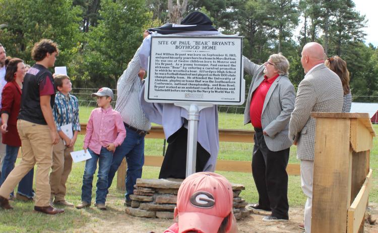 NEW MARKER FOR COACH PAUL “BEAR” BRYANT - Family members of the late Coach Paul “Bear” Bryant (left) and Marty Ryall, director of Arkansas Heritage, unveiled a new state historical marker designating the boyhood home of the legendary college football coach. Born in 1913 in Moro Bottom, Bryant grew up near the Smith Chapel community in southwestern Cleveland County. The marker is located on Hwy. 8 between Fordyce and New Edinburg.