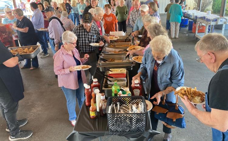 CHOW LINE - Veterans and their guests along with other attendees go through the serving line at the Cleveland County Veterans Appreciation Dinner held Saturday at the fairgrounds in Rison. All veterans and a guest enjoyed a catfish and chicken buffet prepared by Dorey’s Catfish. This year was the 10th anniversary of the dinner.
