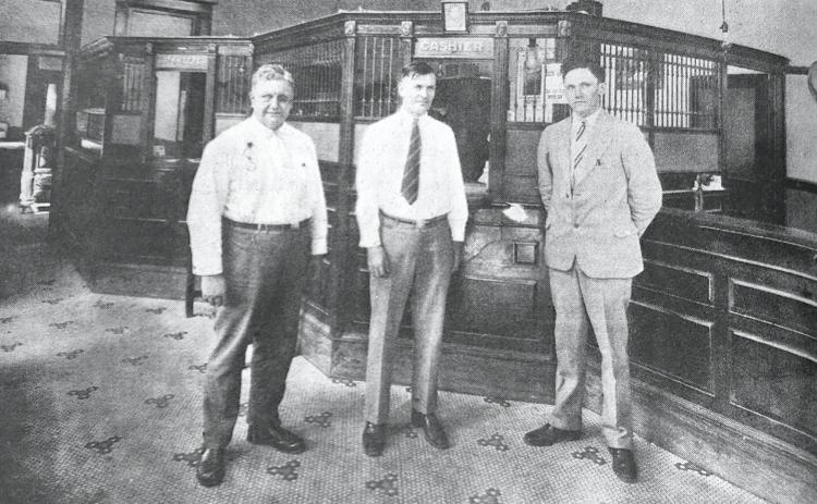 GLIMPSES  FROM  THE  PAST - This glimpse from about 1928, shows the inside of the Bank of Rison when it was located on the northwest corner of Second and Main streets. Identified in the photo are, left to right, J.W. Elrod, H.G. Attwood and Searcy Elrod. Later the bank was located at the southeast corner of Second and Main, and today, Gateway Bank (formerly The Bank of Rison) is located at the northeast corner of Second and Main. For questions or comments, contact Stan Sadler at sadler.stan@yahoo.com