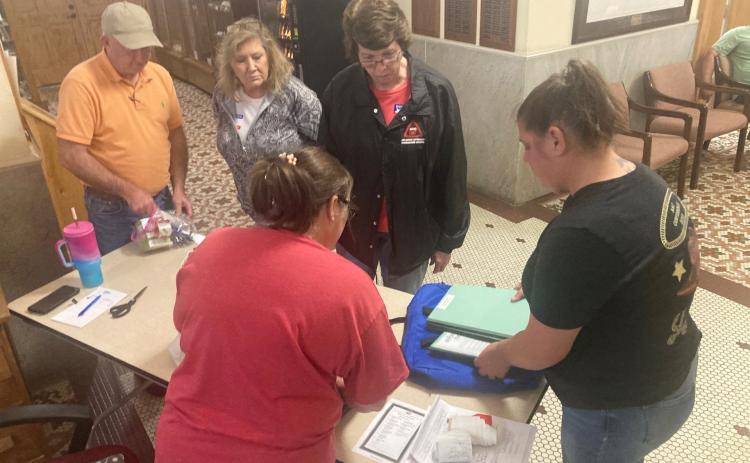 FIRST RETURNS - Cleveland County Election Coordinator Billy Bowlin (left) and Cleveland County Clerk Brandy Herring (right) check in the first returns presented at the Cleveland County Courthouse from Tuesday’s general election. Bowlin reported that the election went relatively smooth Tuesday with no technical issues reported from any of the polling sites across the county.