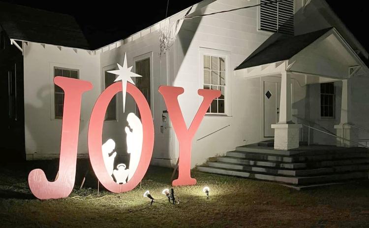 A large, lighted JOY sign greets visitors as they pass by  First Baptist Church of New Edinburg.