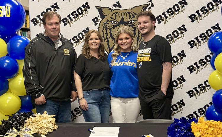 Pictured left to right: Cleveland County School District Superintendent Davy King, Rison Cheer Coach Kim Kaye King, Cayla Johnson, SAU Cheer Coach Trevor Blankenship.