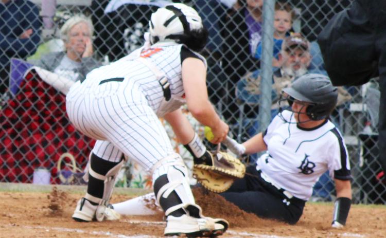 SAFE AT HOME - Woodlawn’s Bay Aud beats the tag at home as she scores on the Lady Bears’ seven first-inning runs Saturday against Magnet Cove.