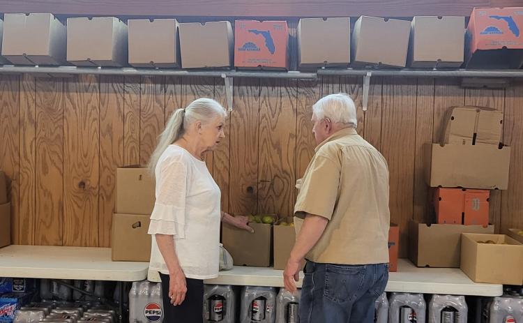 STOCKING THE PANTRY - Pam Martin (left) and Charles Rodgers (right) are two of dozens of volunteers who assist with the Rison United Methodist Church Food Pantry. To help stock the pantry, which serves over 100 families each month, the church is hosting a Dorey’s Catfish dinner Thursday, May 8. (Photo courtesy Barbara Cox)