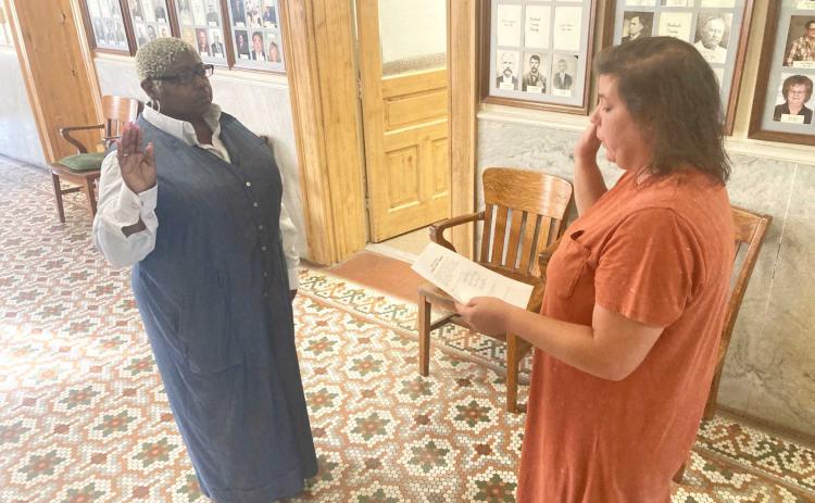 YOUNG SWORN IN - Newly-appointed Rison Recorder/Treasuer Nadine Young (left) is sworn into office Wednesday morning by Cleveland County Clerk Brandy Herring.