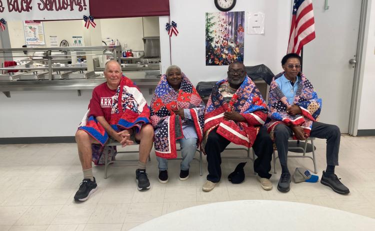 QUILTS OF VALOR - Four veterans from the Rison area were presented Quilts of Valor during a ceremony Tuesday morning at the Cleveland County Senior Citizens Center. Those receiving the quilts were (left to right ) William Threlkeld, Nadine Young, Thomas Young and John Young. Another veteran scheduled to receive a quilt, Mark Young, was unable to attend.