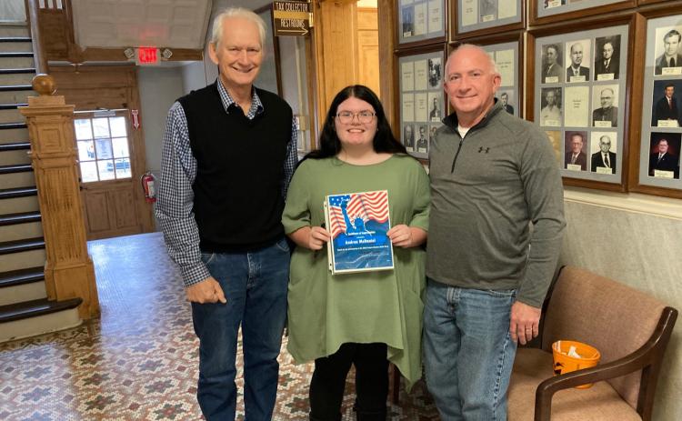 Andrea McDaniel (left), a senior at Rison High School, reads the name of a candidate after selecting it from a bucket held by Cleveland County Election Coordinator Billy Bowlin (center) as Rosemary Sinclair (right), a candidate for Cleveland County Judge, looks on. The ballot draw for the March 2, 2026 primary election was held last Thursday, Nov. 4, in the hallway outside the county clerk’s office at the courthouse in Rison.