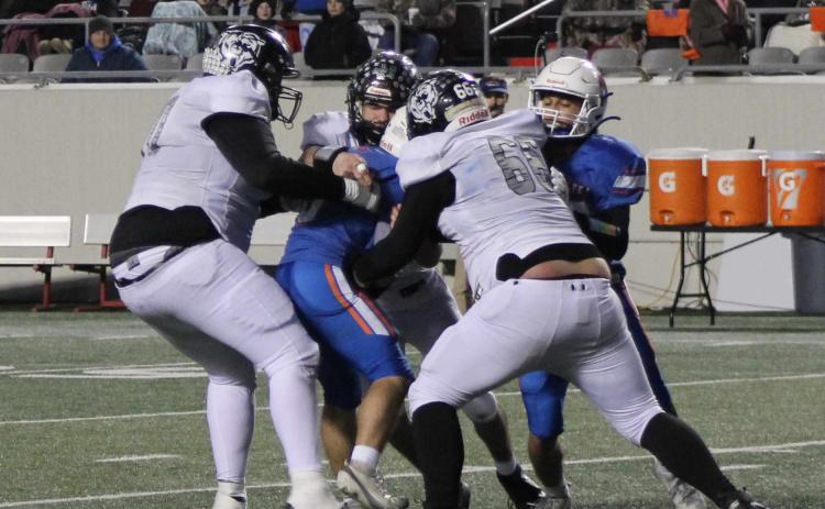 TACKLES FOR LOSSES - Despite giving up more than 500 yards of total offense, the Woodlawn defense did have it moments. Here, Woodlawn seniors Aiden Powell (left), Matthew Green (center) and Dakota Campbell trap a Cedar Ridge running back in the backfield for a loss. The Bears had 10 tackles behind the line of scrimmage for 55 yards in losses.