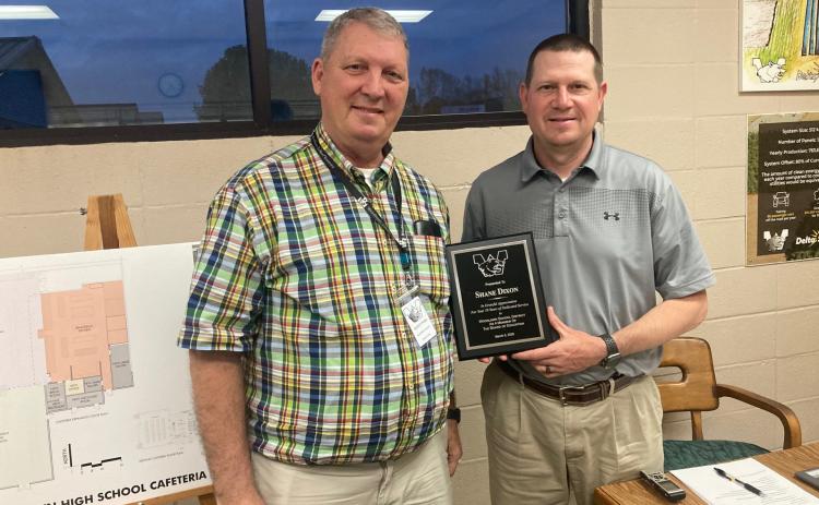 Woodlawn Superintendent Dr. Kevin Hancock (left) presented outgoing Woodlawn School Board President Shane Dixon with a plaque recognizing his 10 years of service on the school.