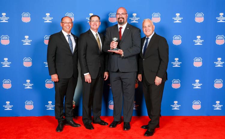 From left: Steven Bybee, senior vice president-Operations; Rod Doerr, vice president and chief safety officer; John Varnell, locomotive engineer; and Jim Vena, CEO.
