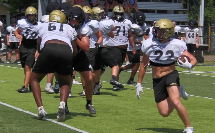 FINAL SUMMER CAMP FOR WILDCATS - Aidan Bitely (no. 22) follows the block of Dedrick Wells (no. 61) for a nice gain against the Smackover Buckaroos during Tuesday’s football camp hosted by Rison at George Walker Field of Champions. Bitely, a transfer from White Hall, is one of the new skill players that will be lining up for the Wildcats this season as Coach Chris Vereen looks to diversify the offense.
