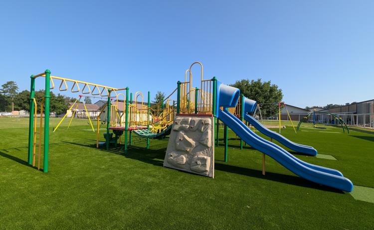 NEW WOODLAWN ELEMENTARY PLAYGROUND - Crews are making the finishing touches this week on some all new playground equipment that will greet students at Woodlawn Elementary when they return to school next month. Woodlawn invested $178,343.66 in the new equipment that features swings, swinging bars, slides, a rock wall and more all on top of a cushioned artificial surface.