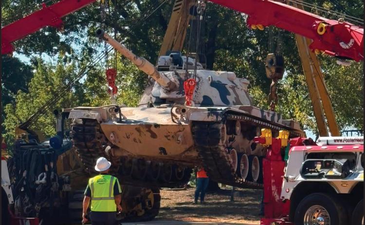 SETTLING INTO ITS NEW HOME - Cranes from Foster Towing of Pine Bluff and Grace Railroad Contractors of Star City lower the 50-plus ton M60 tank into place at Veterans Park in Rison Saturday morning. The tank was previously on display at Hamburg. (Photo compliments of Brad Young)