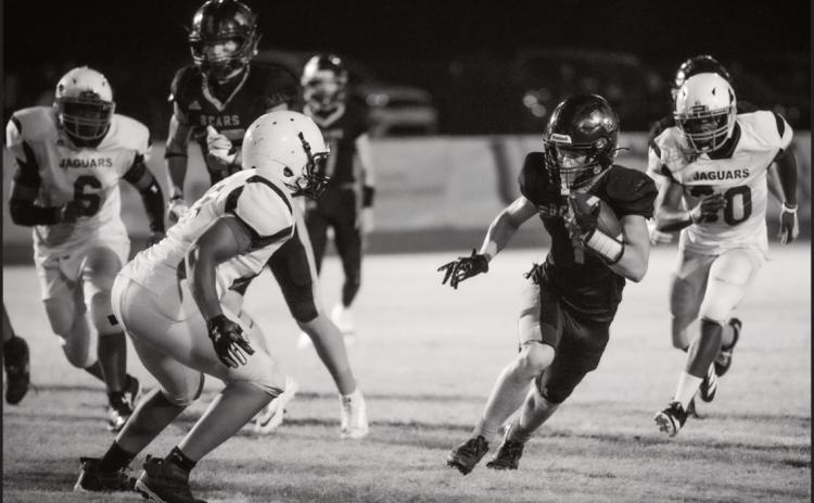 CAREER NIGHT FOR MANES - Woodlawn’s junior running Griffin Manes looks to get outside a Friendship Aspire defender during the Bears’ 52-14 homecoming victory over the Jaguars Friday night at the Carl Jones Sports Complex. Manes rushed for 308 yards on 16 carries with five touchdowns.  (Photo by Kelvin Scott of Cardboard Sports)