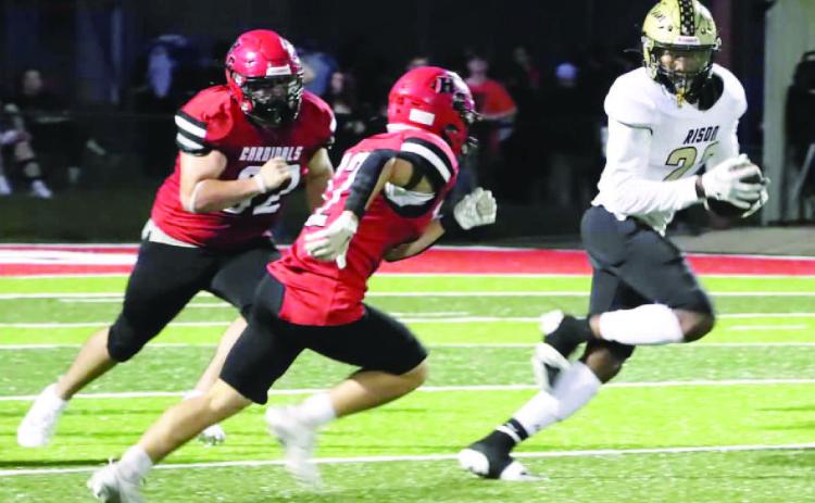 BREAKING LOOSE - Rison running back Christian Reeves (right) eludes a couple of Harmony Grovbe defenders before racing 78 yards for a touchdown to give the Wildcats a 28-7 lead in the second quarter. Reeves finished the game with 144 yards on 10 carries. (Photo by Chris Phillips)