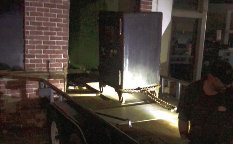 REMOVING SAFE - Johnny Howard and his crew remove the 4,500-lb. safe from the old Cash Grocery store on Main Street last Thursday evening.