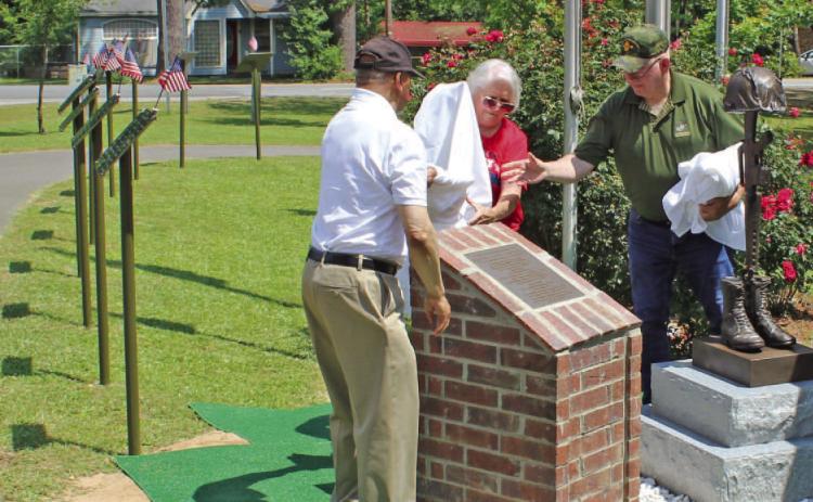 DANNY JACKS MEMORIAL STATUE UNVEILING - Col. Ralph Tildon, retired U.S. Army Reserves, (left) and Mrs. Marcel Jacks (center), wife of the late Staff Sgt. Danny Lee Jacks of Rowell, unveiled a statue and plaque that were erected in Jacks' honor at the Cleveland County Veterans Park in Rison Saturday morning. Tildon served as an executive officer in the same Army company as Staff Sgt. Jacks in Vietnam. The two became close friends in annual reunions that the company held after the