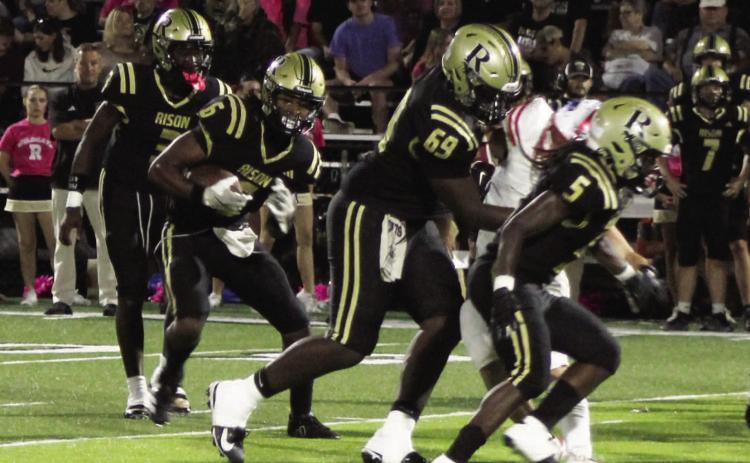 DOMINATING RUN GAME - Rison quarterback Kyson Walker (left, 3) hands off to running back Jaquis Rauls (second from left, 6) as he follows the blocks of Javis McGhee (69) and Jeremiah Marshall (5) for a gain Friday night against Palestine-Wheatlery. Walker finished with 230 yards rushing and four touchdowns as the Wildcats amassed 421 yards rushing. Marshall had 128 yards on the ground while Rauls scored what turned out to be the winning touchdown late in the fourth quarter.