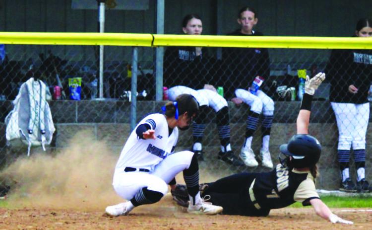 SAFE AT THIRD - Woodlawn third baseman Kathryn Dixon just misse s the tag on Rison's Riley Hyatt as she slides into third base with her triple in the third inning.