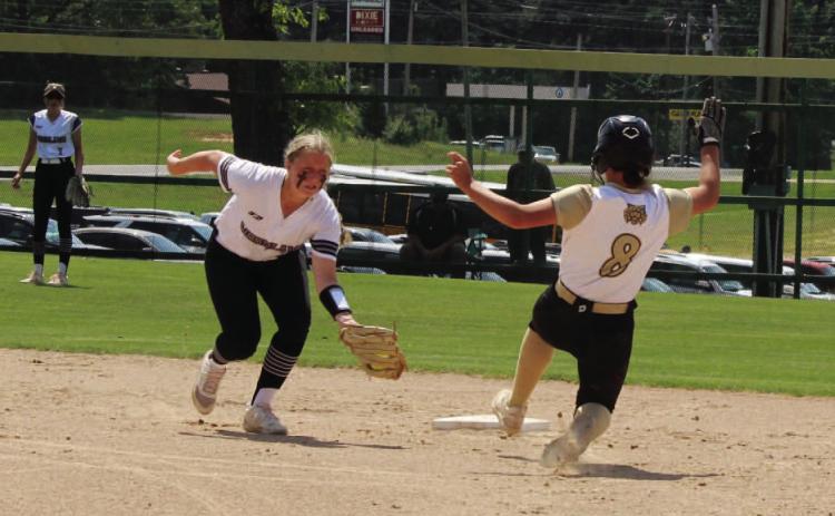 STEALING SECOND - Rison's Layne Potter (right) begins her slide beneath the tag of Woodlawn's Kendall Tooke (left) during first inning action of Saturday's Clas 2A South Region championship game. Potter went on to score what would be the first of five runs for the Lady Wildcats in the opening frame.