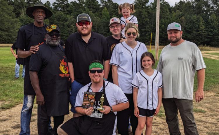 PEOPLE'S CHOICE CONTEST ($175 PRIZE) - Devin Herron (center) an d his Senor Winkey's Team won first place in the People's Choice Contest. Also pictured are Penny Morris' Bar-B-Crew (left) in third place, and Travis McDaniels's Outcast BBQ (right) in second place.