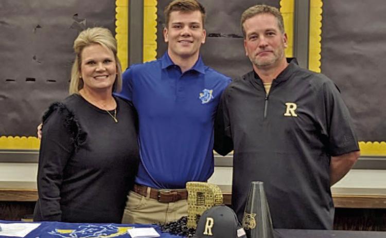 Canon is pictured here with his mother, Leslie Cope (left), and his father, Chad Cope (right), after signing his letter intent inside the library at Rison High School.