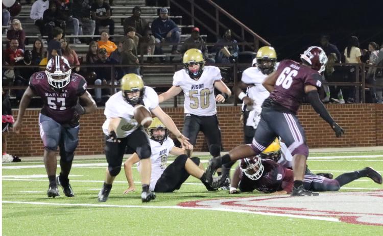 YARDLEY RECOVERS FUMBLE - Rison senior defensive end Dolten Yardley (left, no. 64) pulls In a Barton fumble mid-air as teammates Avery Hopson (on ground, no. 8) and Ayden Laws (no. 50) during first half action of last Friday’s 6-3A clash at Barton. Wildcat Coach Clay Totty commended Yardley and Hopson for playing through sickness Friday night.