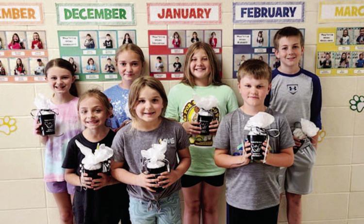 WOODLAWN ELEMENTARY STUDENTS OF THE MONTH - These students exhibited "Commitment," which was the May 'Paw'sitive word of the month. Pictured are, Back Row: Josie Young (4th grade), Maci Holland (5th grade), Emalyn Clement (3rd grade), Brit Swan (6th grade); Front Row: Macie Marcantel (1st grade), Millie Sowrheaver (kindergarten), Jace Gavin (2nd grade).