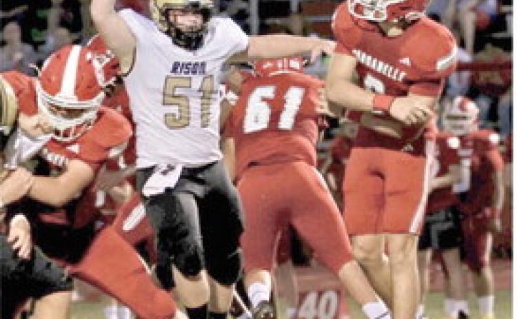 DEFENSE STEPS UP IN SECOND HALF - Rison's Ryan Cottrell (no. 51) brings the heat on Dardanelle quarterback Creed Vega during last week's non-conference game at Dardanelle. (Photo by Kim Kaye King)