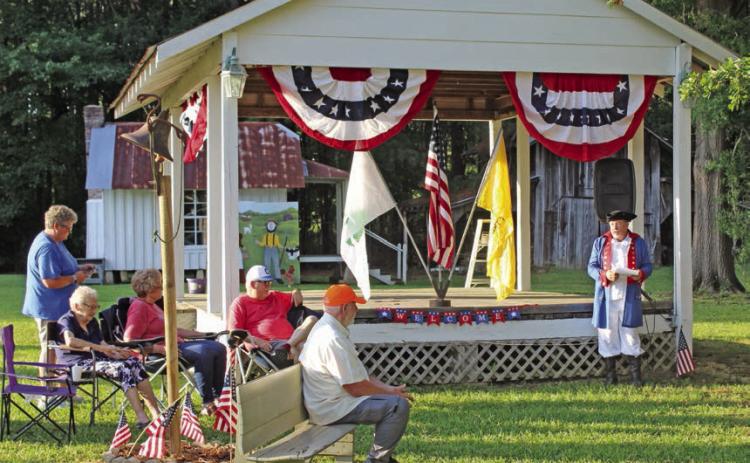 Rick Beckner of New Edinburg (right), dressed in a replica Continental Army costume, started the festivities by reciting the events and circumstances surrounding the foundation of the United States in 1776.