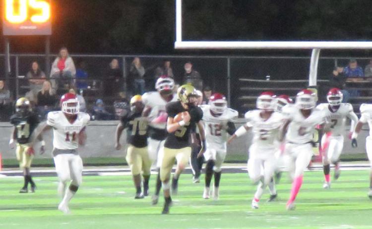 OFF TO THE RACES - Rison quarterback Blaine Dixon busts through the line of scrimmage on his way to a 64-yard touchdown run late in the fourth quarter to help put away the scrappy Lake Village Beavers. Dixon had an outstanding night in all three phases of the game. On offense, he rushed for 163 yards, the most by a Wildcat quarterback in more than 50 years, while completing his only pass of the game for an 83-yard touchdown.On special teams, he blocked a point-after attempt while successfully kicking three