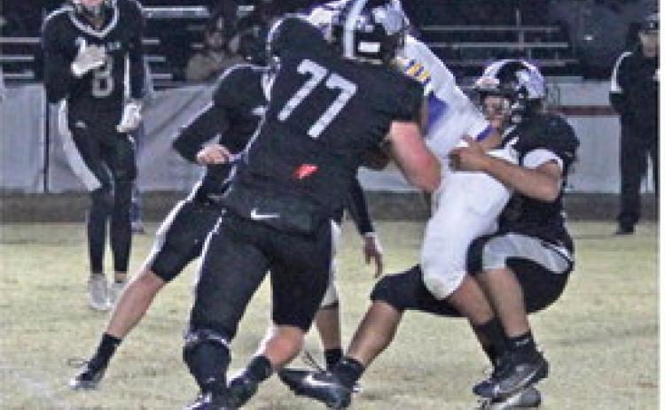 BIG STOP FOR BEARS - After Spring Hill had scored on three cons ecutive possession in the first half, Goodlawn's Ryan Rauls (right) stopped Spring Hill's big All-State running back Terry Tipton for no gain on first down, eventually forcing a three-and-out. Goodlawn Coach Zach Meyer said it took them more than a quarter to figure out a better way to defend against a new wrinkle that Spring Hill had installed with its triple option. Closing in to assist on the tackle is Goodlawn's Brayden Kitchens (no. 77) ,