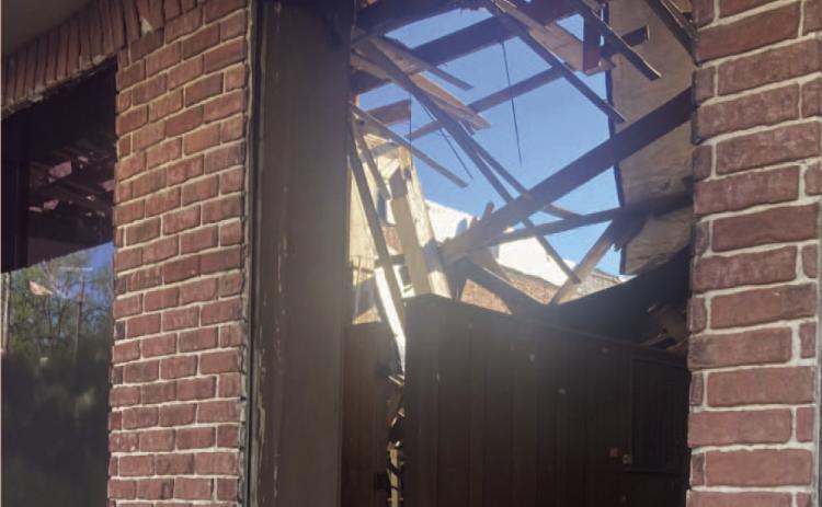 DOWNTOWN BUILDINGS - While the clean-up of residential properti es will be a major focus for Mayor Charles Roberts, he also said he intends to address some of the buildings in the downtown area. This photo taken of a broken front window of the old Cash Grocery building on Main Street in downtown Rison reveals that the roof has collapses the entire length of the structure. Roberts said he intends to discuss the Cash building during the next city council meeting.