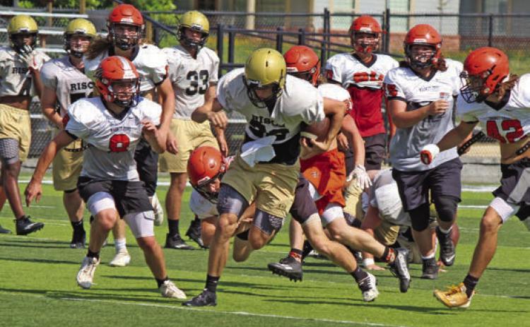 MORRISON ON THE RUN - Rison quarterback Owen Morrison shakes off a Magnet Cove defender during last Thursday’s team camp at George Walker Field of Champions. Wildcat Coach Caleb Carmikle said Morrison has picked up the run-pass option well, and will give opposing defenses something else to think up in the upcoming season. Carmikle said Morrison has deceptive speed for his size.