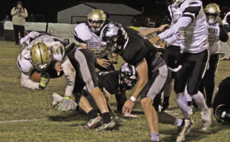 WOODLAWN 60, BRINKLEY 16 - Woodlawn's Landen Booth (left) brings Brinkley's Jeremiah Harris as he meets the 6-4, 220-pound quarterback at the line of scrimmage during first half action of the Bears' 60-14 win in the first round of the Class 2A eight-man state playoffs at the Carl Jones Sports Complex. Woodlawn travels to Izard County Friday night for a chance to arn a spot in the Dec. 1 state championship game at War Memorial Stadium in Little Rock. (See story page 9)