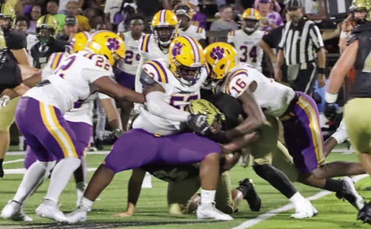 TOUGH RUNNING - Rison senior running back Treyvione Wainwright is met at the line scrimmage by Dumas' Ja'Vyon Walker (no. 52) and Timothy Martin (no. 16) during first half action from Friday night's 2023 season opener at George Walker Field of Champions. Wildcat Coach Caleb Carmikle said the Bobcats' size and strength upfront made it difficult to run against. Rison finished with 88 net yards of rushing. (Photo by Christine Phillips)