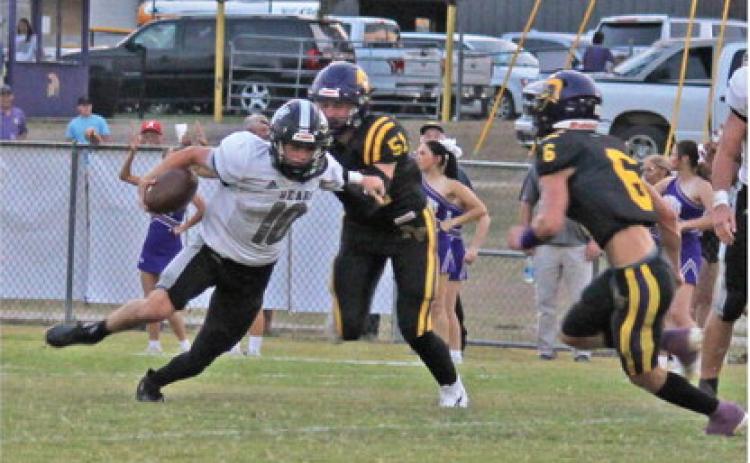 BREAKOUT GAME FOR MOORE - Woodlawn junior quarterback/running b ack Aden Moore (no. 10) left elude the tackle of Praire View's Will Waggoner (no. 51) and Hayden Little (no. 6). Moore, who saw limited action as last year's back-up quarter, had a breakout game as he rushed for 106 yards with an 83-yard touchdown run and completing a 52-yard touchdown pass to Ethan Adair. Moore played both quarterback and I back in the game.